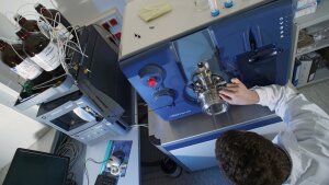 Scientist working on tandem mass spectrometer